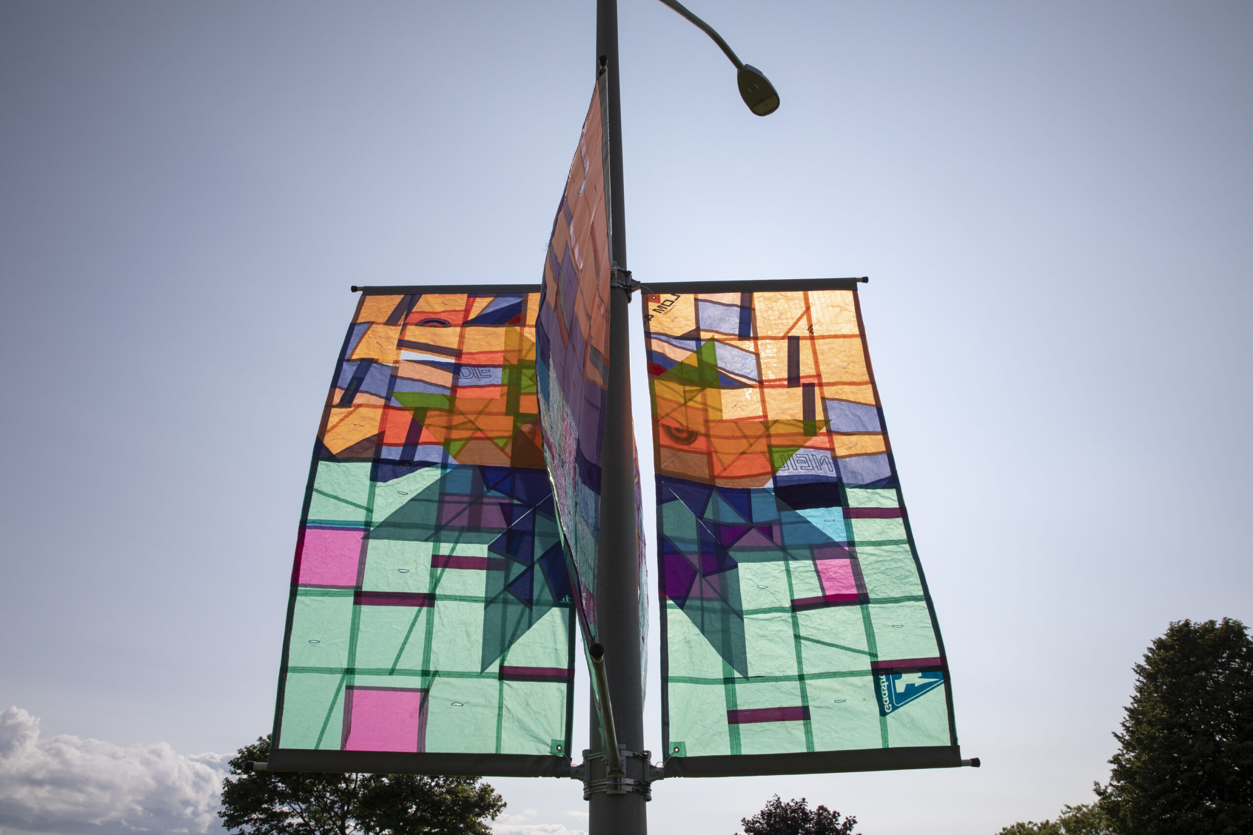 Cover Me with the Sea, 2023, quilted windsurf sails, 4 banners each 3’x6’, installation variable