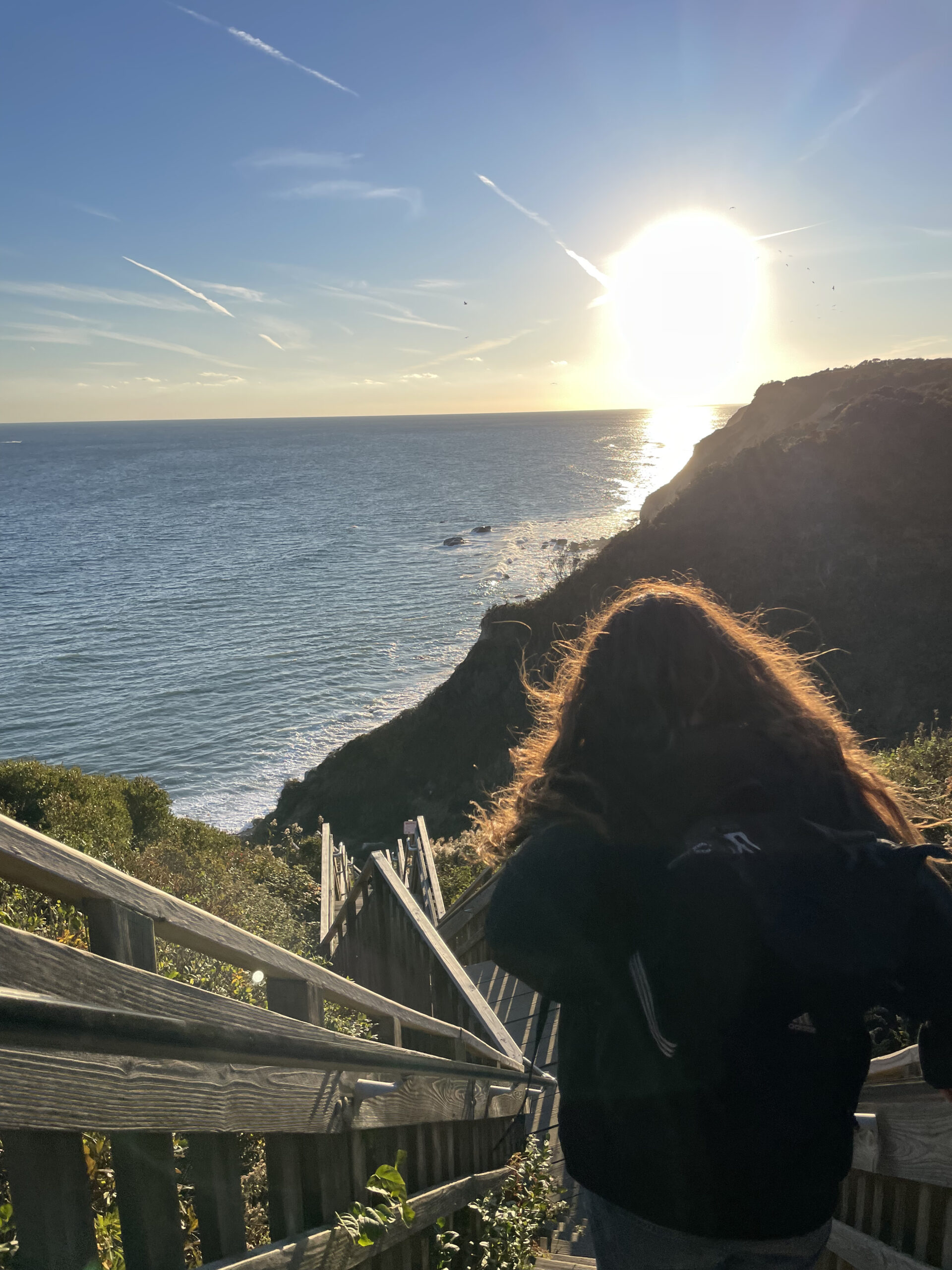 Looking down at the ocean from a set of stairs.